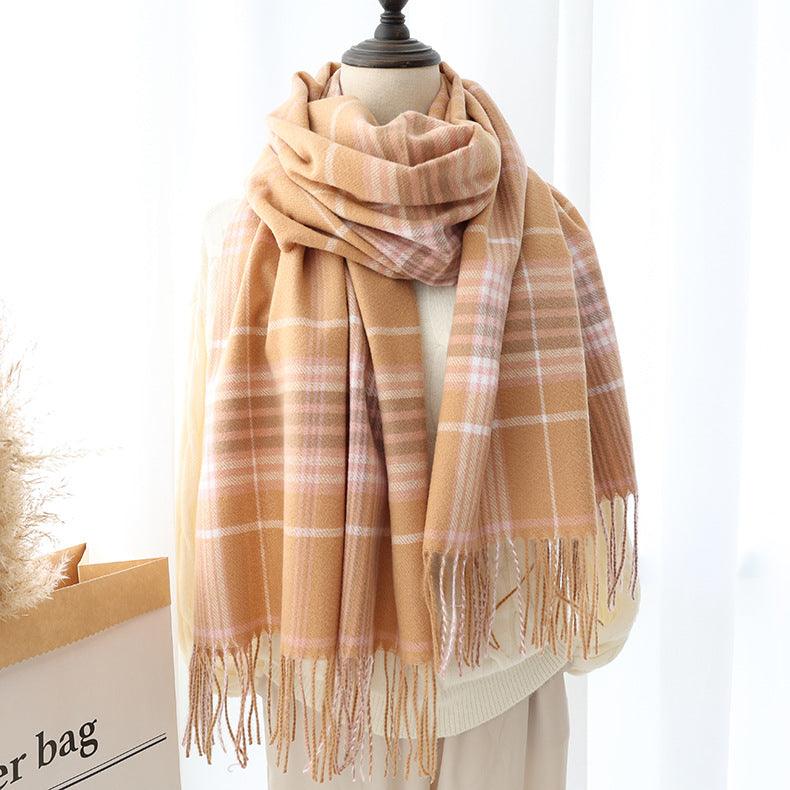 Thick long shawl scarf in light tan plaid with fringed ends, draped
