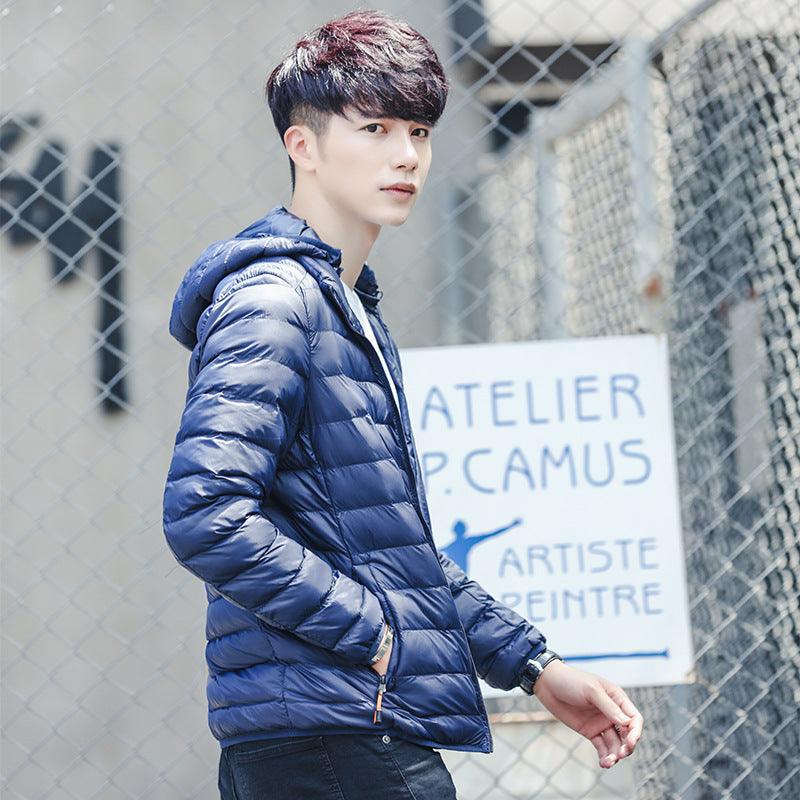 Men's hooded padded jacket in blue, full-zip front with quilted baffle pattern.