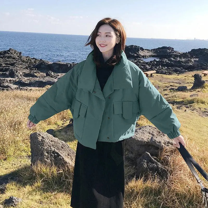 Green short jacket with hood, button front, and large flap pockets at chest and waist