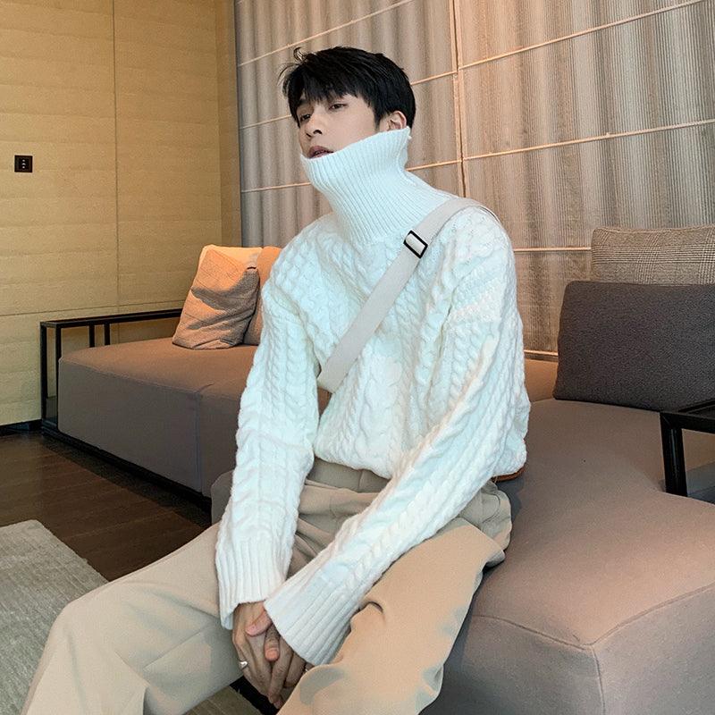 Light blue turtleneck cable-knit sweater with long sleeves and ribbed cuffs