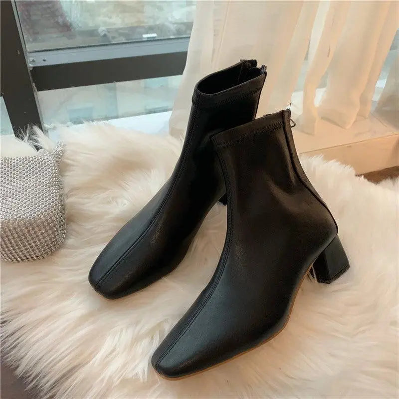 Black soft leather ankle boots with mid block heel and pointed toe