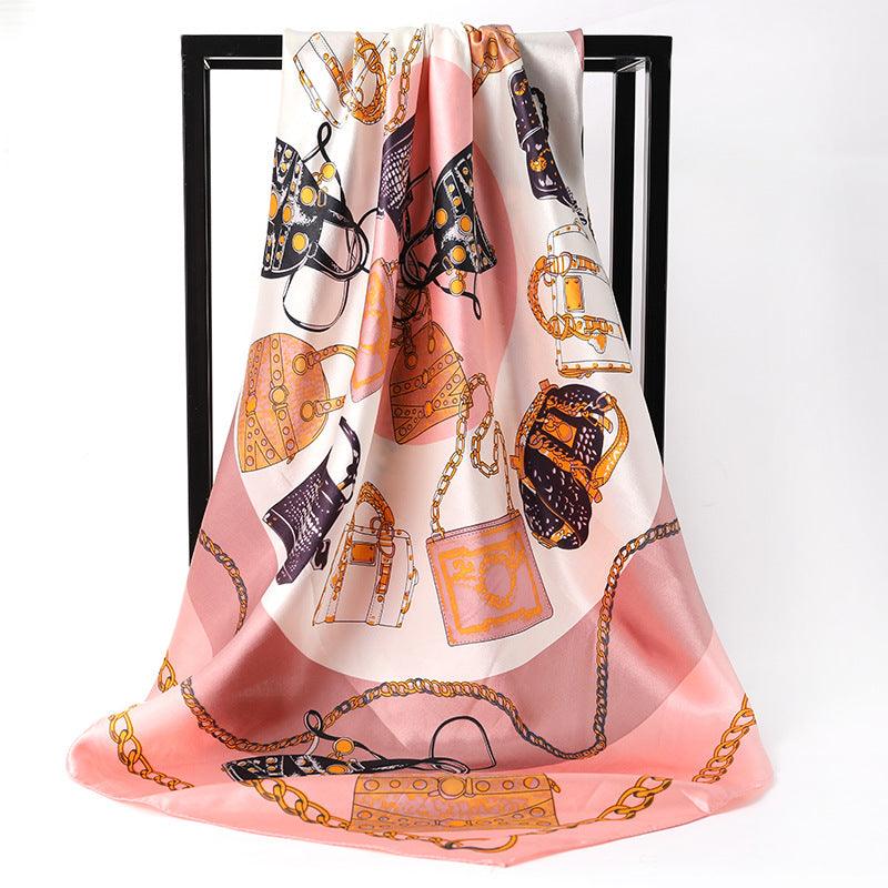 Women's silk scarf in blush pink with orange and gold chain jewelry motifs