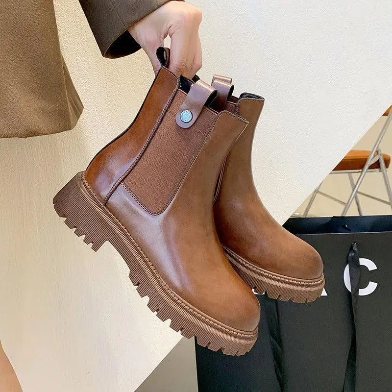 Brown Chelsea-style Martin boots with side elastic panels and chunky lug sole