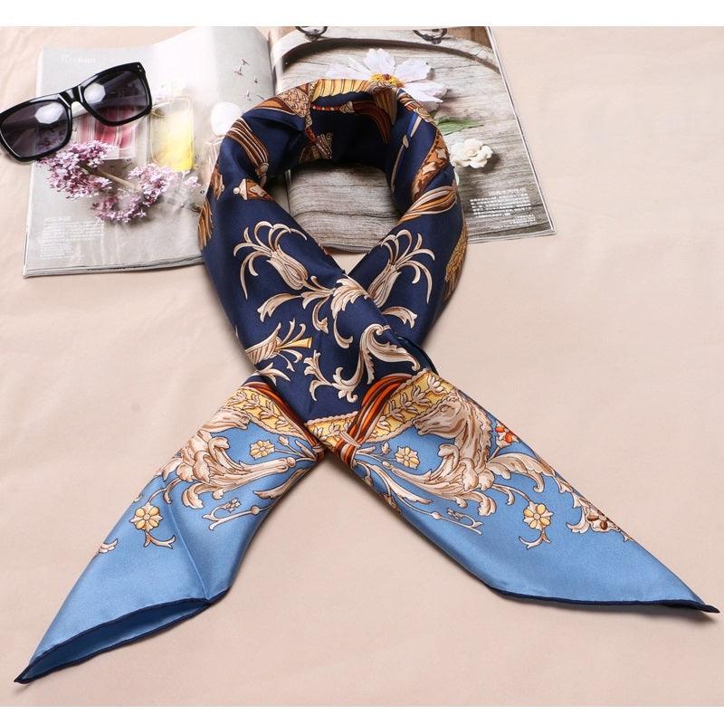Navy silk scarf with gold and light-blue baroque swirl print, folded triangular