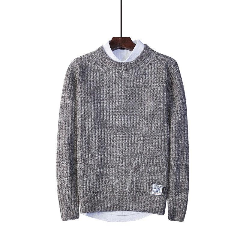 Crew neck sweater in speckled light grey knit, ribbed collar, cuffs, and hem.