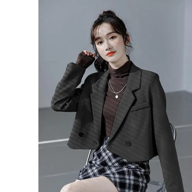 Black short suit jacket with notch lapels and flap pockets, two-button front.