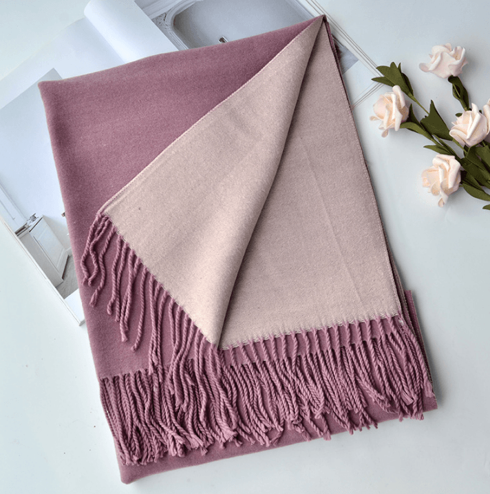 Warm cashmere scarf in mauve and light beige with fringed border.