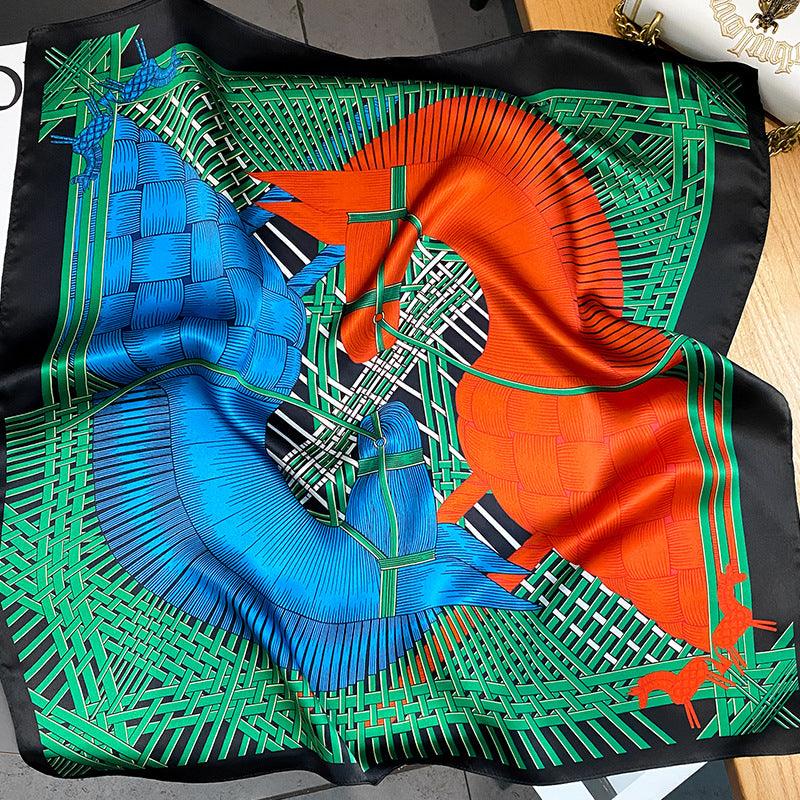 Green, blue, and orange geometric patterned silk scarf with braided grid design.