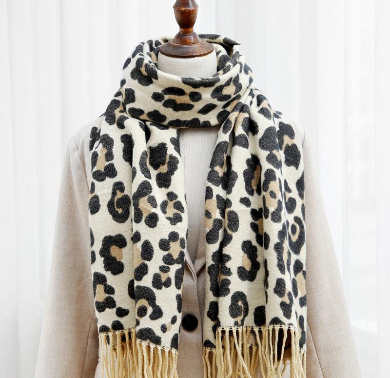 Double-sided leopard print scarf with cream and black pattern and tassel fringe ends