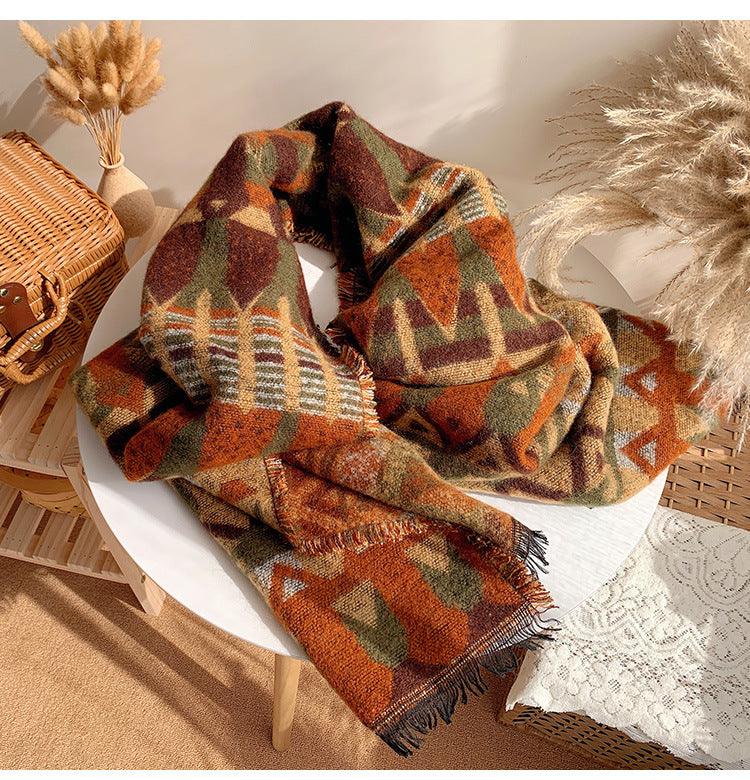 Thick plaid wool shawl in orange, green, and brown plaid with long fringe ends